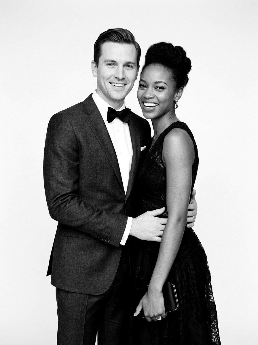Couple in formalwear posing for a black and white studio portrait