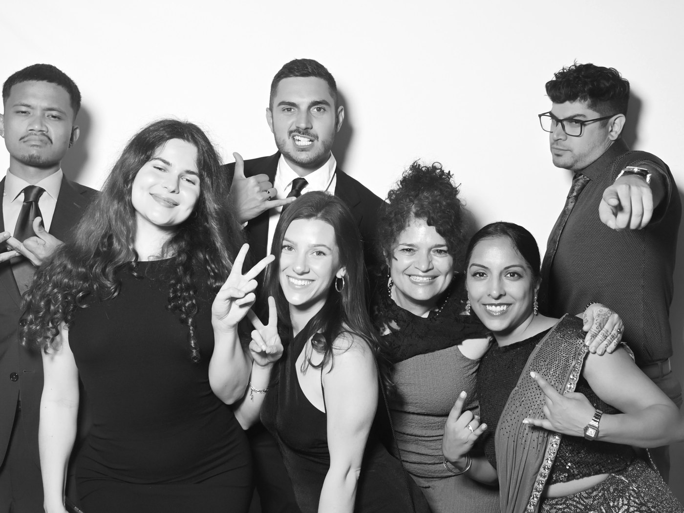 Group of friends laughing together in a black and white portrait